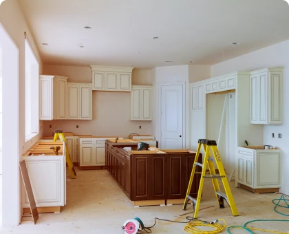 Kitchen cabinetry mid-renovation with a yellow step ladder