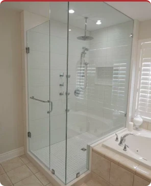 Glass-enclosed shower and bathtub in a renovated bathroom
